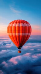 Obraz premium Vibrant hot air balloon soaring above the clouds at sunset