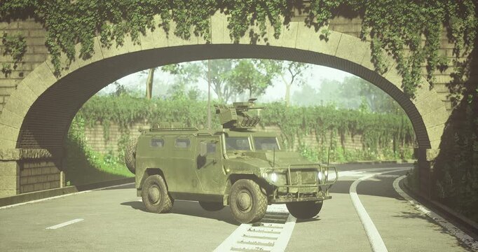 A robust military vehicle navigates through a picturesque archway surrounded by lush greenery, showcasing its rugged design against the tranquil backdrop of nature.