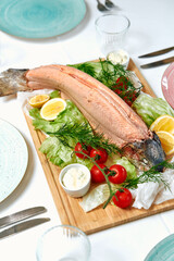 A Fresh Seafood Platter Featuring Tender Salmon Fillet Surrounded by Crisp Lettuce, Zesty Lemon Slices, Cherry Tomatoes, and Creamy Dip Garnished with Dill