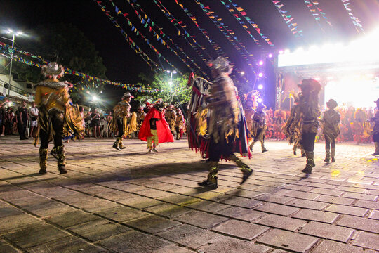 Silhouettes of dancers in traditional indigenous-inspired costumes during a performance of the Bumba Boi folk dance in the city of S&atilde;o Luis, Maranh&atilde;o, Brazil