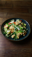 Stir-fried bok choy or pak choy with scrambled eggs, showcasing vibrant green and golden colors. Healthy cooking, Asian cuisine, food blogs, and recipe illustrations. Close up