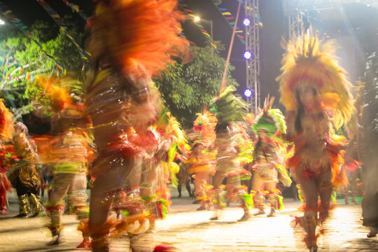 Silhouettes of dancers in traditional indigenous-inspired costumes during a performance of the Bumba Boi folk dance in the city of S&atilde;o Luis, Maranh&atilde;o, Brazil