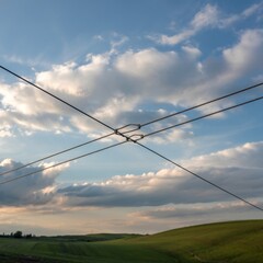 Overhead wires against cloudy sky clouds blue