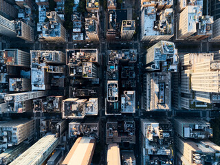 Aerial view of Midtown Manhattan skyline at sunset with iconic buildings and Hudson River in the background. g.