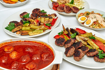 A Delightful Array of Grilled Meats, Vegetables, and Savory Dishes Showcased on a Dining Table, Perfect for Sharing and Enjoying with Family and Friends