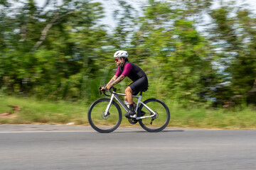 Fototapeta premium Speeding cyclist in race with motion blur effect