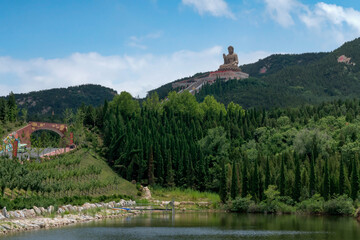 The Great Buddha Statue in the Nanshan scenic area of the Jiaodong Peninsula on a sunny summer day, Longkou, Yantai, Shandong, China
