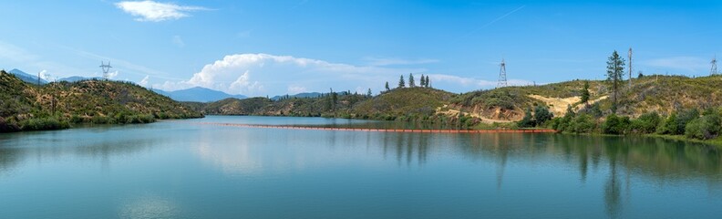 Panorama of the orange boom in the Sacramento River upstream from the Keswick Dam at Redding, California, USA