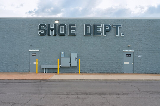 New Hartford, NY - Jul 25, 2025: Shoe Dept. Signage on the wall of employees entrance, is an American footwear retailer based in Concord, NC and has 63 years of experience owned by Shoe Show, Inc.