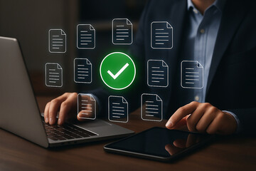 Businessman reviewing digital documents on laptop and tablet