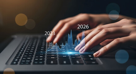 Close-up of hands typing on laptop keyboard, futuristic glowing graph overlay, 2023-2026 financial growth projection, modern business technology concept.