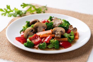 Stir fried vegetables, champignon mushroom, broccoli, bell pepper and carrot with soy sauce, Asian vegetarian food, Healthy eating