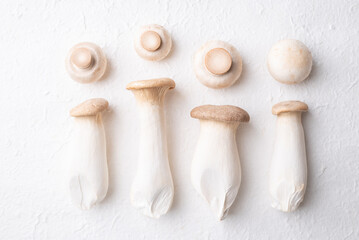 Top view of fresh Champignon mushroom (botton mushroom) and King oyster mushroom (Eryngii Mushroom) on white background