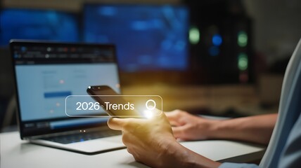 Person using smartphone to authenticate login on laptop screen with secure password entry and digital lock icon symbolizing online security and data protection