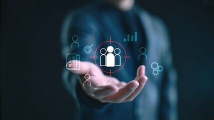 Businessman holding a glowing holographic interface displaying a group of people icon and business analytics data