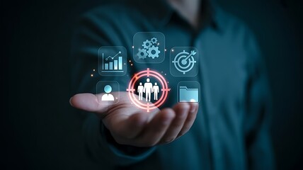 Businessman holding a glowing digital interface displaying team collaboration business goals and performance analytics in a futuristic concept