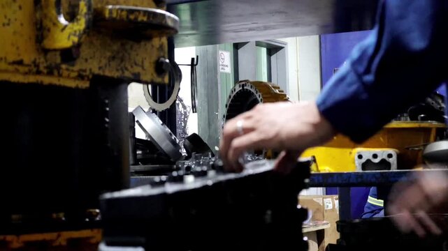 Mechanic is dismantling the automatic allison transmission control valve for inspection and repair. 