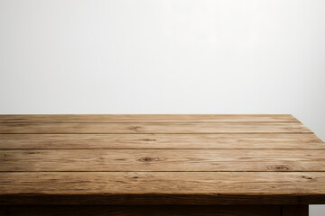 Naklejka premium Wooden Table Surface: A rustic wooden table showcases its rich texture and natural grain against a clean backdrop, inviting viewers to envision possibilities