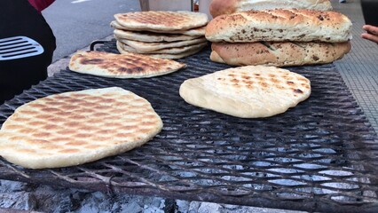 Street vendor grilling flatbreads in buenos aires