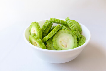 Bitter melon or bitter gourd in a bowl on white background