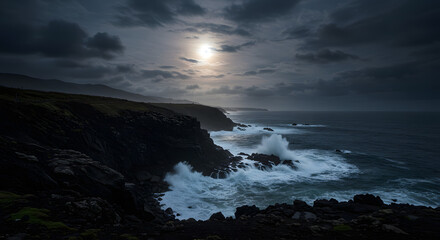 Fototapeta premium Dramatic coastal scenery with crashing waves under a moody sky at dusk with moon light