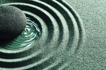 Serene zen garden rock with water ripples for meditation app backgrounds, spa center promotions, yoga studio wall art, mental health book covers