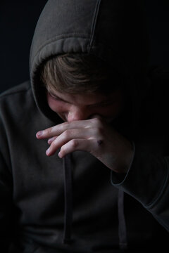 Portrait of a teenage boy laughing and looking down