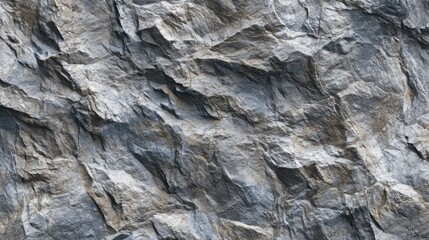 Fototapeta premium Close-up view of a rocky surface showcasing diverse textures and muted colors. The rugged terrain reflects natural geological formations, typical during daylight hours in mountainous areas.