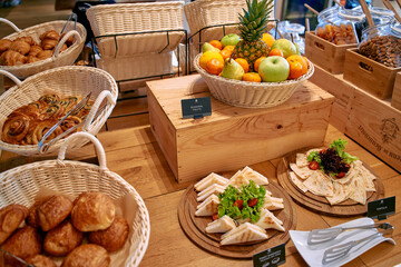 A Vibrant Array of Fresh Fruits and Delicious Pastries Displayed Artfully in Baskets and Wooden Platters at a Cozy Café Setting