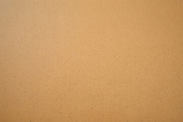 Light brown textured paper background with subtle speckles, offering a neutral and versatile surface for design elements