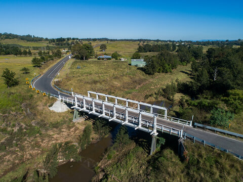 aerial image of Beckers Bridge crossing Webbers Creek in Glendon Brook on sunlit day