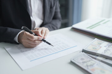 Fototapeta premium Businesswoman Accountant analyzing investment charts Invoice documents. Accounting Bookkeeper Clerk&nbsp;Bank Advisor And Auditor