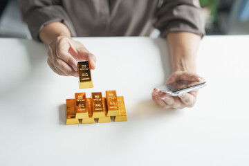 Senior mature older asian woman Trading Investments in gold saving for retirement Gold Trading business woman online Trading gold on the stock exchange