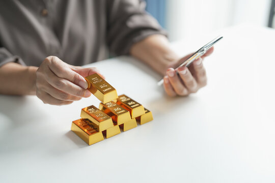 Senior mature older asian woman Trading Investments in gold saving for retirement Gold Trading business woman online Trading gold on the stock exchange - Powered by Adobe