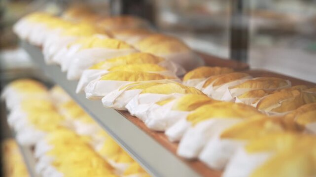 Fresh durian neatly packed in individual portions for first-time tasting at local market