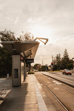 Light rail stop at Newcastle Beach along road with cars passing