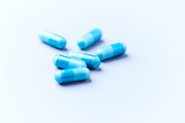 Amino acids capsules on bright background. Soft focus. Close up. Copy space.