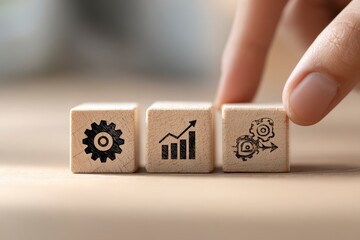 Hand touches wooden blocks with gear, graph, and mechanism icons