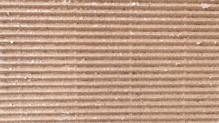 Torn brown corrugated cardboard piece isolated on white background. Kraft corrugated cardboard texture with horizontal stripes. Piece of brown cardboard blank for text or design.
