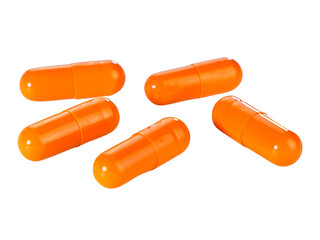 Bulk orange capsule pills isolated on white background.