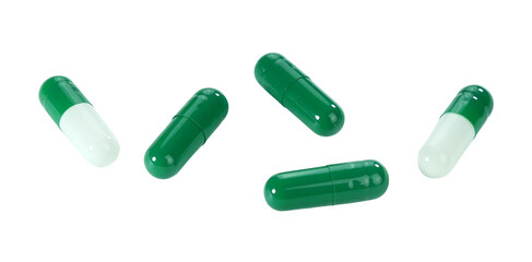 Bulk green and white capsule pills isolated on white background.