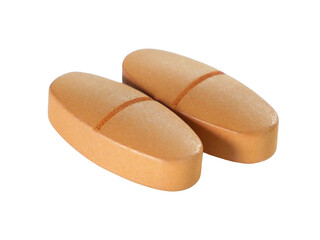 Bulk brown pills isolated on white background.