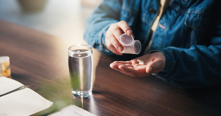 Water, medicine and hands of woman in home for medical treatment, prescription and tablets for recovery. House, health and person with medication container for vitamins, supplements or pills on table
