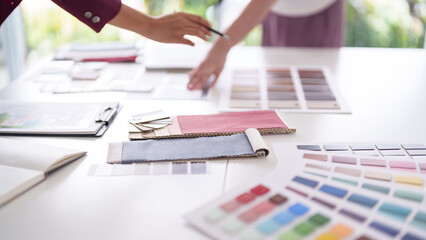 Architects interior designers collaborate home design select color palettes fabric samples client project planning creative studio environment