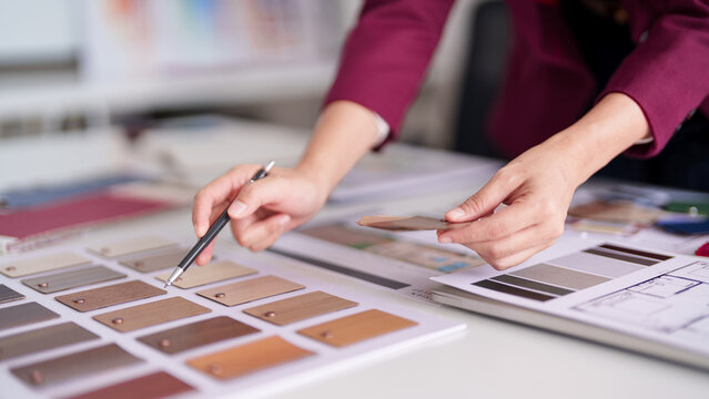 Asian adult professional architect selects interior design material color palette for home renovation property development