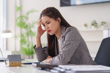 Asian business professional woman stress real estate property financial challenge office desk home...