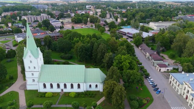 Aerial Panorama of Dobele Town Center and Evangelical Lutheran Church at Summer Scenic Drone View in Golden Hour Light Over Dobeles Historic Center on a Warm Summer Evening Peaceful Latvian Town