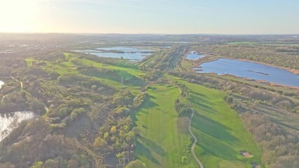 Stunning High angle view of Waterfront Golf club lush fairways and lakes under clear skies in Rotherham, South Yorkshire, UK.