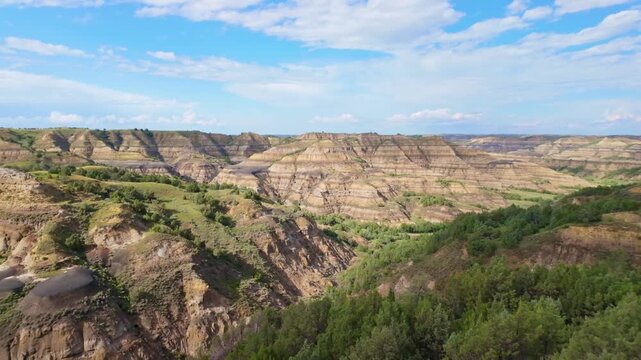 A sweeping panoramic view captures the dramatic landscapes along the Caprock Coulee Trail at Theodore Roosevelt National Park
