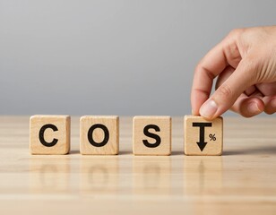 Wooden blocks spelling 'COST' with a hand placing a down arrow symbol on a light wooden table.